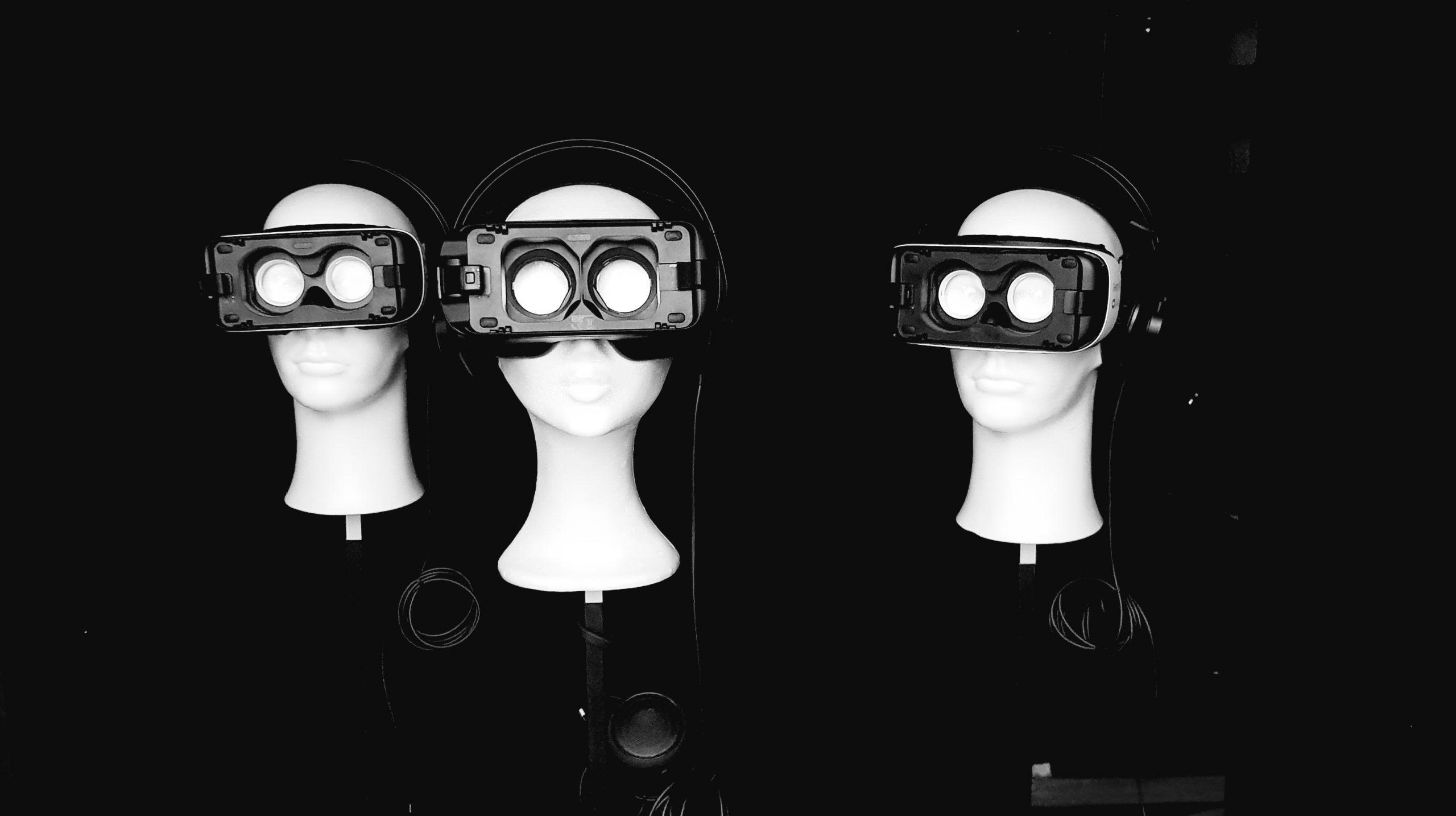 three styrofoam heads with empty VR glasses
